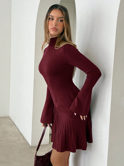 Woman wearing long turtleneck knitted dress facing forward