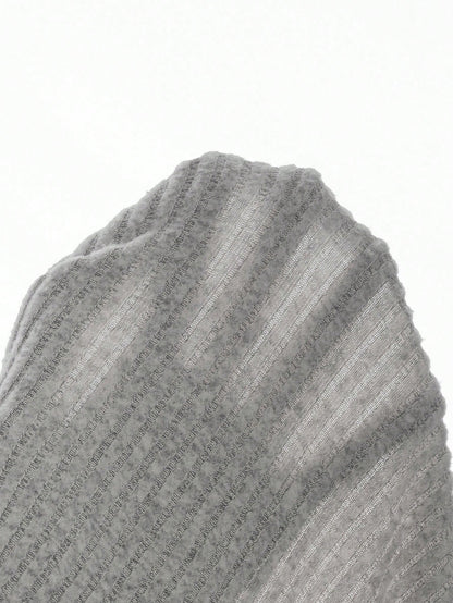 Woman taking a mirror selfie wearing a gray knit dress with a white collar, holding a pink phone. Nushes