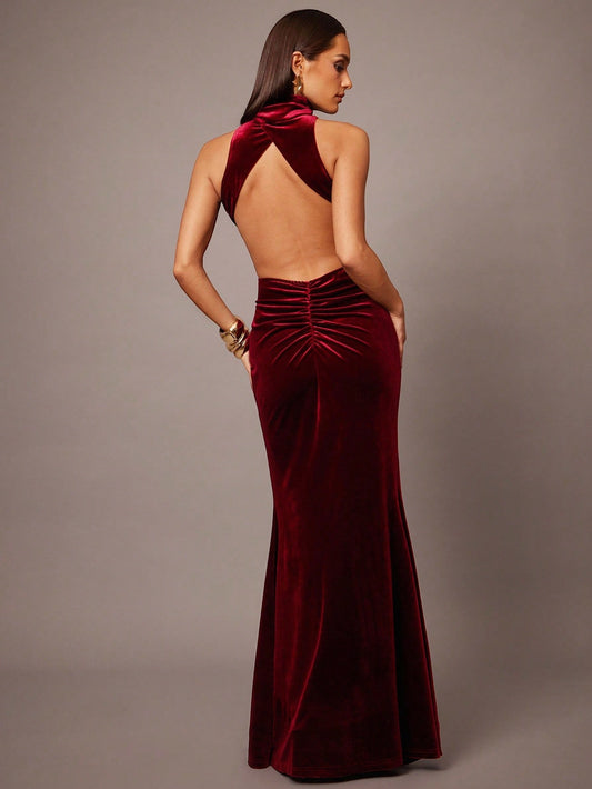 Elegant women’s velvet maxi dress with high neck and open back, designed for evening and formal events.